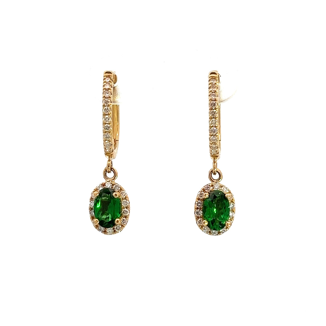 Introducing the Modern 14kt Yellow Gold Earrings, featuring 1.20cttw Tsavorite Garnets and .40cttw Diamonds. These elegant earrings showcase oval-shaped green Tsavorite Garnets encircled by small diamonds, each designed as a diamond-adorned hoop with the gemstone hanging gracefully as a pendant, creating an exquisite dangle effect against a white background.