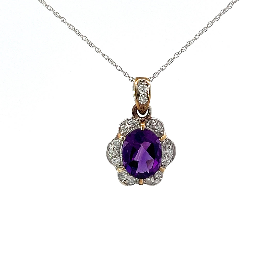 A stunning Mid Century 14kt white gold necklace showcasing a delicate design with a 2-carat amethyst stone at the center, surrounded by .26-carat total weight of sparkling diamonds in a flower-like arrangement. The pendant's polished, elegant appearance contrasts beautifully against a white background.