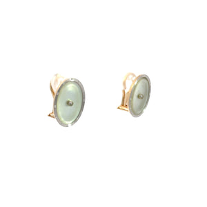 A pair of Art Deco 14kt yellow and white gold Mother of Pearl Omega back earrings, designed with round, green-toned gemstones and gold trim. These vintage-inspired earrings are displayed on a plain white background.