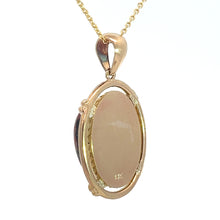 Load image into Gallery viewer, The Late Century 14kt Yellow Gold 5ct Boulder Opal Fancy Frame Pendant features a light-colored boulder opal encased in a decorative gold frame. The pendant is attached to a thin 14kt yellow gold chain with a large bail, adding vintage charm to its simplistic design and emphasizing the polished surface of the opal.