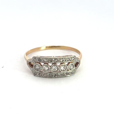 The Edwardian Platinum & 18kt Yellow Gold 1.00ct Antique & Rose Cut Diamond Ring showcases a rectangular silver setting adorned with a row of five round, sparkling diamonds. Reminiscent of the Edwardian era, this elegant piece is surrounded by intricate filigree detailing and is displayed against a plain white background.