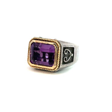 Load image into Gallery viewer, The Late Century Konstantino Sterling Silver &amp; 18kt Yellow Gold 5ct Emerald Cut Amethyst Ring showcases a substantial, rectangular purple gemstone encased in elegant 18kt yellow gold accents. This exquisite piece is adorned with an intricate design on the sterling silver band, featuring detailed metalwork on either side of the amethyst. The vivid ring is set against a white background.