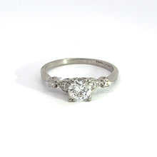 Load image into Gallery viewer, A close-up of the Art Deco Platinum .50ct Old European Cut and .28cttw Old Mine Cut Diamond Ring, exuding vintage jewelry charm with its central round diamond flanked by two smaller diamonds on either side. The ring is set against a plain white background.