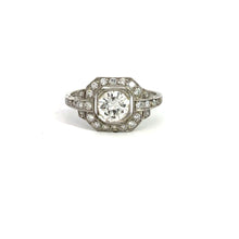 Load image into Gallery viewer, The Late Art Deco Platinum .91ct Round Brilliant Cut Diamond + 1.16cttw Diamond Ring epitomizes vintage sophistication with its central round diamond in an octagonal setting. The band, adorned with smaller diamonds, amplifies the Art Deco elegance of this intricate piece. Displayed against a white background, it radiates timeless charm.