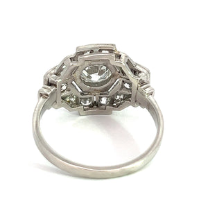 Introducing the Art Deco Platinum .91ct Old European Cut Diamond + 1.60cttw Diamond Ring, featuring an intricate geometric design with numerous small white gemstones. At its center lies a larger old European cut diamond, surrounded by an openwork pattern that enhances its detailed and elegant Art Deco aesthetic.