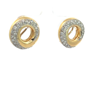 Close-up of a pair of Late Century 18kt Yellow Gold 2.25cttw Round Brilliant Cut Diamond Swirl Earrings encrusted with small diamonds on the upper part of the circle. Each earring features an open center, creating a hollow, donut-shaped design that exudes vintage glamour.