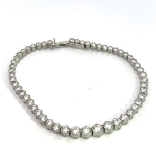 Load image into Gallery viewer, This exquisite Art Deco Platinum 4.90cttw Diamond Bezel Set 7.25inch Bracelet showcases a series of hexagonal segments, each elegantly bezel-set with a round diamond. The bracelet is artfully arranged in a semi-circular shape against a plain white background.