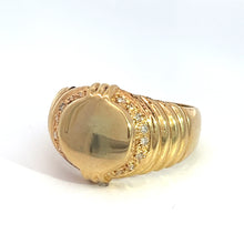 Load image into Gallery viewer, This Late Century 14ky Yellow Gold .24cttw Signet Ring, featuring a smooth, raised center design encircled by sparkling diamonds, is part of our fine jewelry collection. The band boasts intricate ridged detailing on both sides, adding texture and elegance. The ring is beautifully photographed against a plain white background.