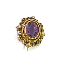 Load image into Gallery viewer, Introducing the Victorian 14ktyg 4.70ct Amethyst + seed pearl pin, a vintage brooch showcasing a stunning oval-shaped amethyst at its center. The gem is encircled by delicate gold filigree and adorned with seed pearls, embodying the timeless elegance and antique charm of Victorian jewelry design.