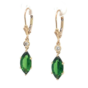 A pair of modern 14kt yellow gold earrings featuring marquise-cut tsavorite garnets totaling 4 carats in a four-prong setting, each adorned with a small round diamond above the green stone, attached to a lever-back closure.