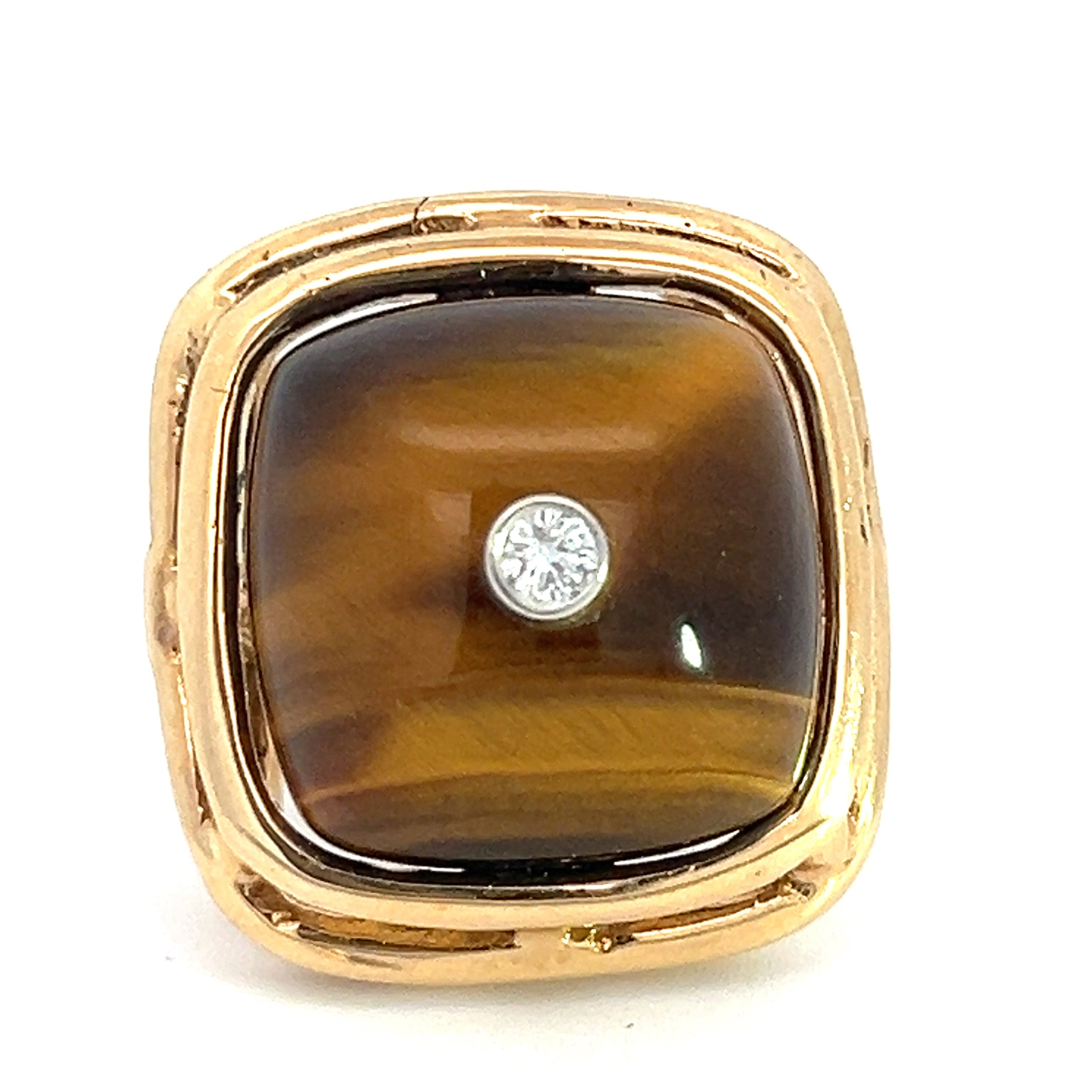 Introducing the Late Century 14ktyg Tiger Eye + .10ct Round Brilliant Cut Diamond ring: a square-shaped gold ring showcasing a polished tiger's eye gemstone, presenting its signature golden and brown bands. The center is adorned with a small, round brilliant cut diamond, all enveloped in a smoothly finished, shiny gold setting.