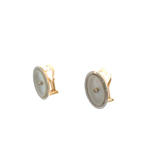 Load image into Gallery viewer, A pair of elegant Art Deco 14kt Yellow &amp; White Gold Mother of Pearl Omega Back Earrings, featuring round, white, opaque stones set in two-tone gold metal. The earrings have a classic, polished look and are positioned against a plain white background.