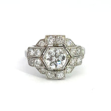 Load image into Gallery viewer, The Art Deco Platinum .91ct Old European Cut Diamond + 1.60cttw Diamond Ring is an ornate, vintage-style piece featuring a large central hexagonal diamond surrounded by smaller diamonds in a geometric arrangement. The platinum band is studded with diamonds, enhancing the ring&#39;s elegant and intricate Art Deco jewelry design.