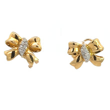 Load image into Gallery viewer, A pair of Mid Century 18kt Yellow Gold .50cttw Bow Earrings adorned with small, dazzling diamonds in the center. The earrings feature a polished, glossy finish with intricate details to mimic the appearance of a tied ribbon, exuding a vintage charm. Set against a white background.