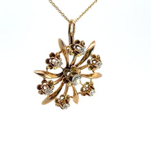 Load image into Gallery viewer, The Victorian 14ktyg .80cttw old mine cut diamond pendant is a stunning gold necklace featuring a circular pendant crafted in the likeness of a floral burst. The pendant showcases an intricate pattern with curved stems, each adorned with small clusters of crystals and a dazzling Old Mine Cut Diamond. The delicate 14kt yellow gold chain perfectly complements the elegant charm of this exquisite piece.