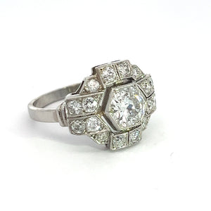 An Art Deco Platinum ring featuring a .91ct Old European cut central diamond, surrounded by smaller diamonds totaling 1.60cttw in a geometric pattern, set against a plain white background.