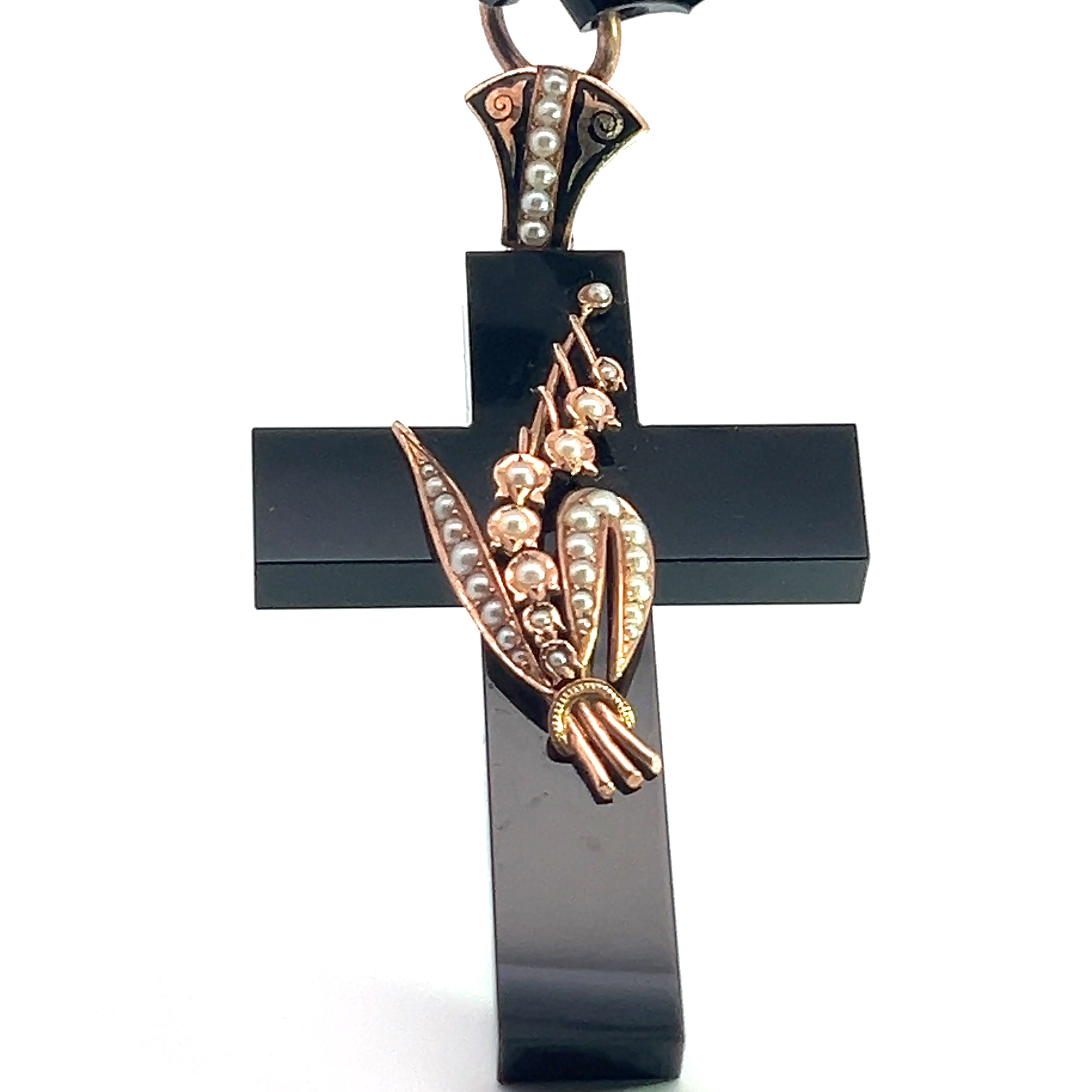 A breathtaking piece of historical jewelry, the Victorian 14kt Yellow Gold Onyx and Seed Pearl Cross pendant features elaborate metalwork and delicate seed pearls. The centerpiece showcases an exquisite gold and pearl design that mimics a flower bouquet, all elegantly suspended on an 18-inch faceted onyx chain with matching decorative accents.
