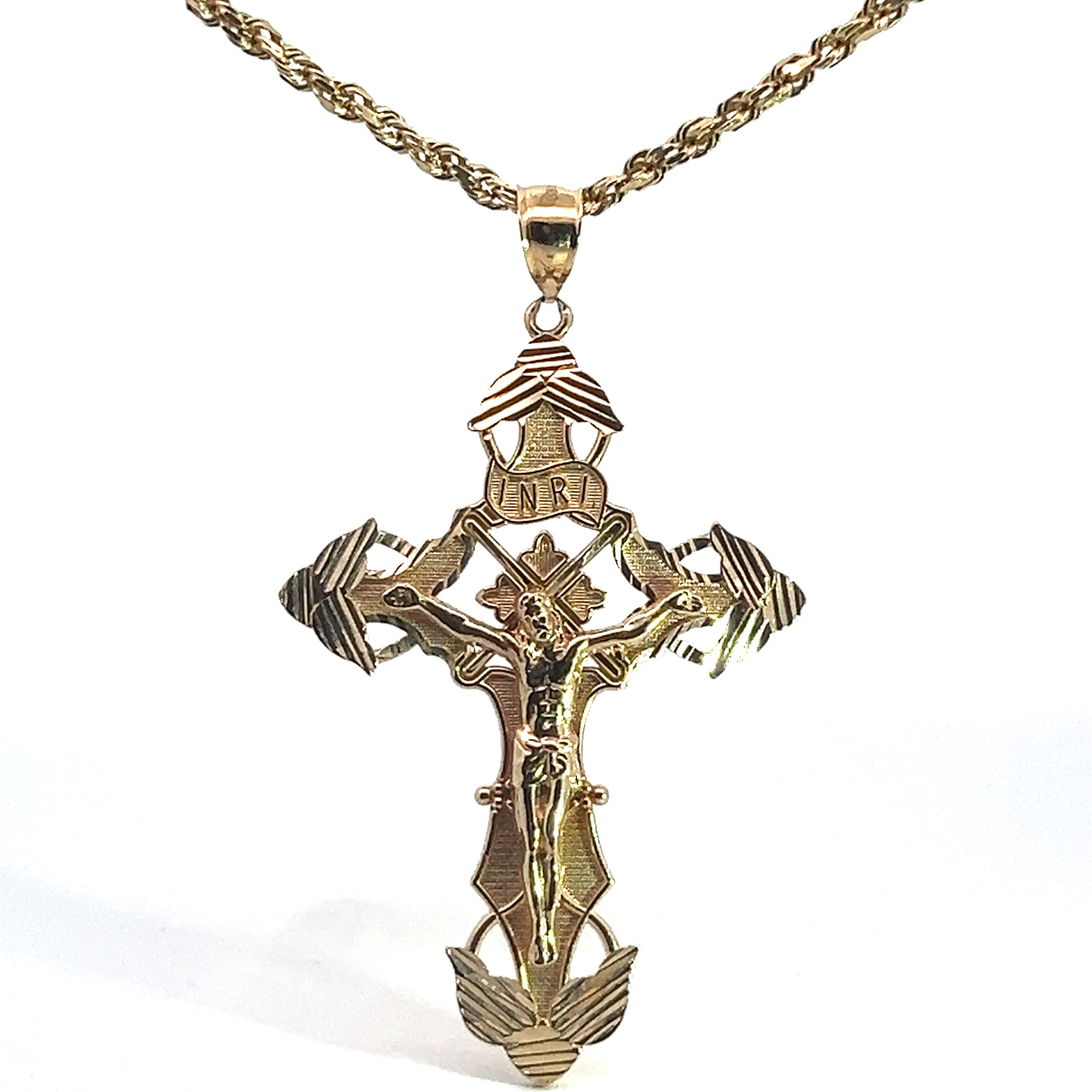 The Late Century 14ktyg Cross on 24 Inch Chain features a gold crucifix pendant with an ornate design and a figure of Jesus Christ on the cross. The top of the cross displays the letters "INRI," and the edges and base are adorned with decorative patterns. The intricately braided chain completes this elegant piece.