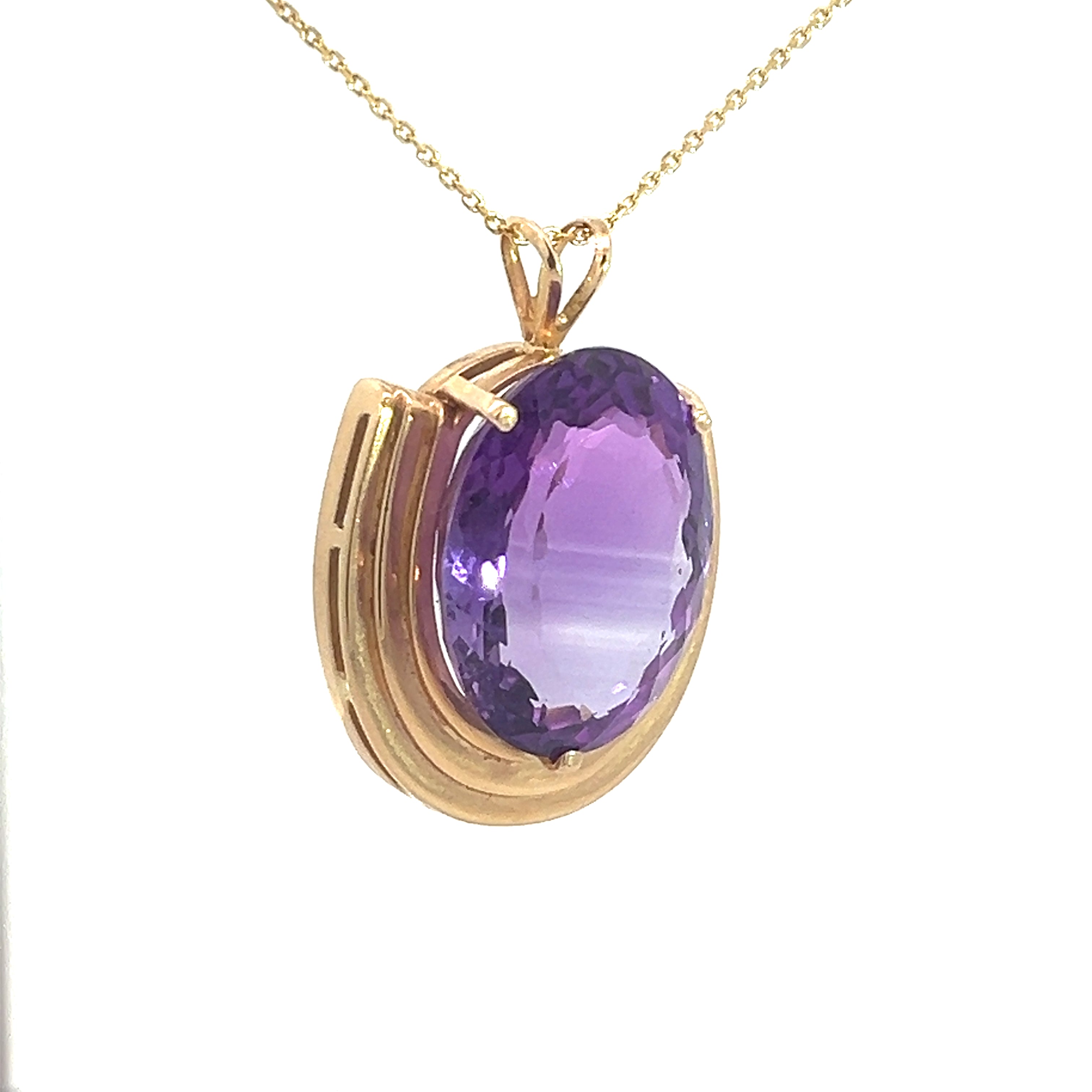 The Late Century 14ktyg 25kct Oval Cut Amethyst Necklace features a vibrant, oval-cut purple amethyst set within a gracefully curved gold frame. This sophisticated and elegant pendant is beautifully complemented by a thin and delicate chain.