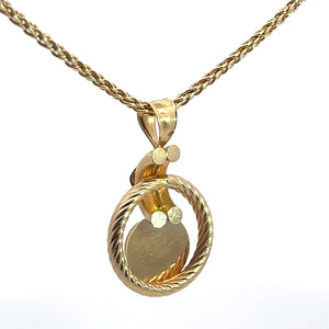 The Victorian 14kt yellow gold pendant, featuring a .50ct cabochon garnet and diamond-cut details, is elegantly suspended on an 18-inch chain. Its contemporary yet classic design boasts both polished and textured surfaces, echoing a hint of Victorian allure that makes the pendant the center of attention against any background.