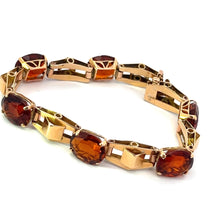 Load image into Gallery viewer, The Retro 14kt Yellow Gold 30cttw Madeira Citrine 7in Bracelet is a delicate piece featuring alternating oval-cut amber and yellow-green gemstones set in 14kt yellow gold bezels, with geometric gold links interspersed throughout. This bracelet embodies retro charm and is designed with a clasp for closure.