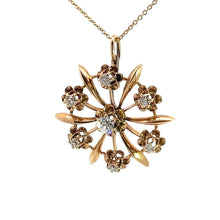 Load image into Gallery viewer, The Victorian 14ktyg .80cttw old mine cut diamond pendant features a golden flower with six petals and six smaller flowers encircling a central Old Mine Cut Diamond, all encrusted with sparkling diamonds. Crafted from luxurious 14kt Yellow Gold, the pendant hangs gracefully from a fine gold chain, epitomizing the elegance of the Victorian era.