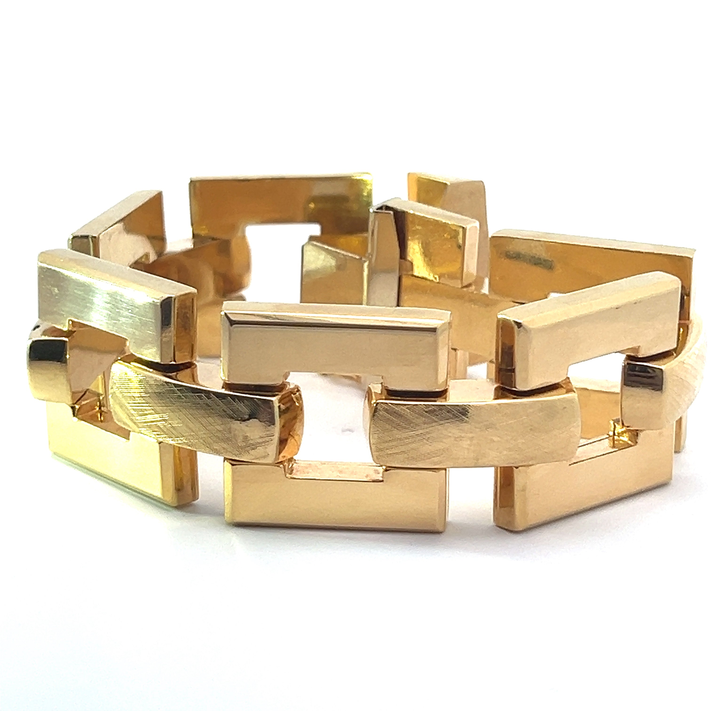 The Late Century 18kt Yellow Gold Brushed & Fancy Link 8in Bracelet showcases a stunning gold link design, featuring an intricate arrangement of rectangular and curved geometric shapes. The polished and slightly brushed finish creates a captivating blend of shiny and matte textures, exuding the elegance of late-century glamour against its white background, which accentuates its timeless style.