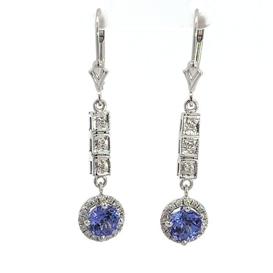 Introducing the Modern 18/14kt 2cttw Tanzanite + .35cttw Diamond Dangle Earrings, a pair of sophisticated drop earrings showcasing three square-cut diamonds cascading into a circular setting that highlights a stunning blue tanzanite gemstone encircled by smaller diamonds. These exquisite earrings feature a polished silver finish and secure latch back closures.