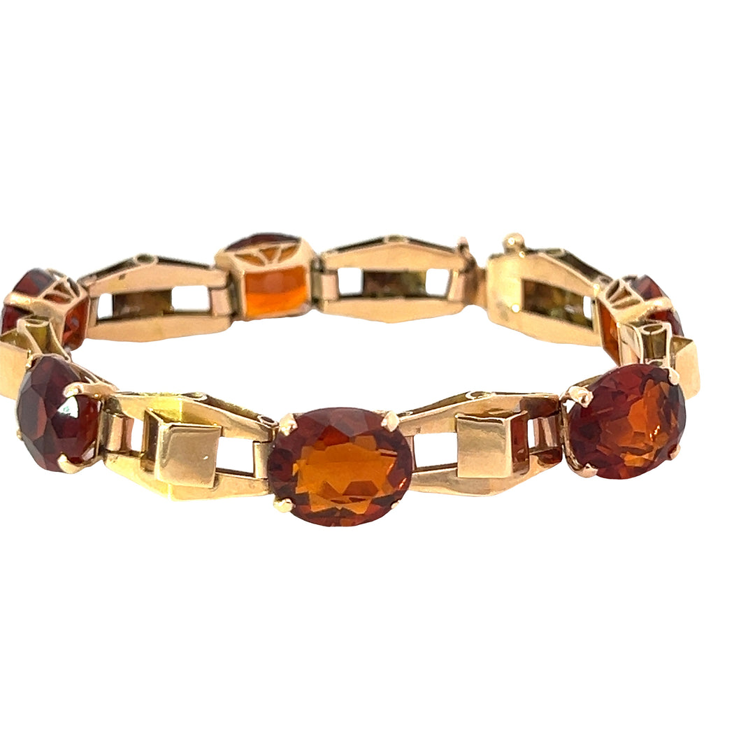 The Retro 14kt Yellow Gold 30cttw Madeira Citrine 7in Bracelet showcases a series of alternating links featuring rectangular gold pieces and oval, deep orange Madeira Citrine gemstones. The bracelet exudes retro charm with its geometric, elegant design, highlighting gemstones mounted in gold settings.