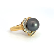 Load image into Gallery viewer, Introducing the Mid Century 14ktyg Black Pearl + 1.25ct Diamond Ring, an elegant yellow gold ring featuring a large black pearl at its center, encircled by a halo of small, sparkling diamonds. The sophisticated design and shiny finish highlight the luxurious combination of the black pearl with the shimmering 1.25-carat diamonds.