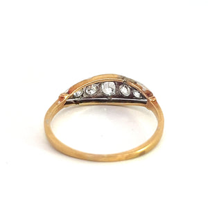 A stunning Edwardian Platinum & 18kt Yellow Gold .50cttw Old Mine Cut Diamond Ring featuring a half-circle design encrusted with five small, round old mine cut diamonds. Viewed from the top against a plain white background.