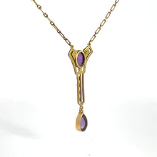 Load image into Gallery viewer, The Victorian 14kt Yellow Gold 3.50cttw Amethyst Pearl Lavalier Necklace features a geometric pendant adorned with purple stones. The elongated design showcases a drop-shaped amethyst at the bottom, complemented by a smaller rectangular amethyst near the top. The chain is composed of small, oval links, exuding the elegance typical of Victorian jewelry.