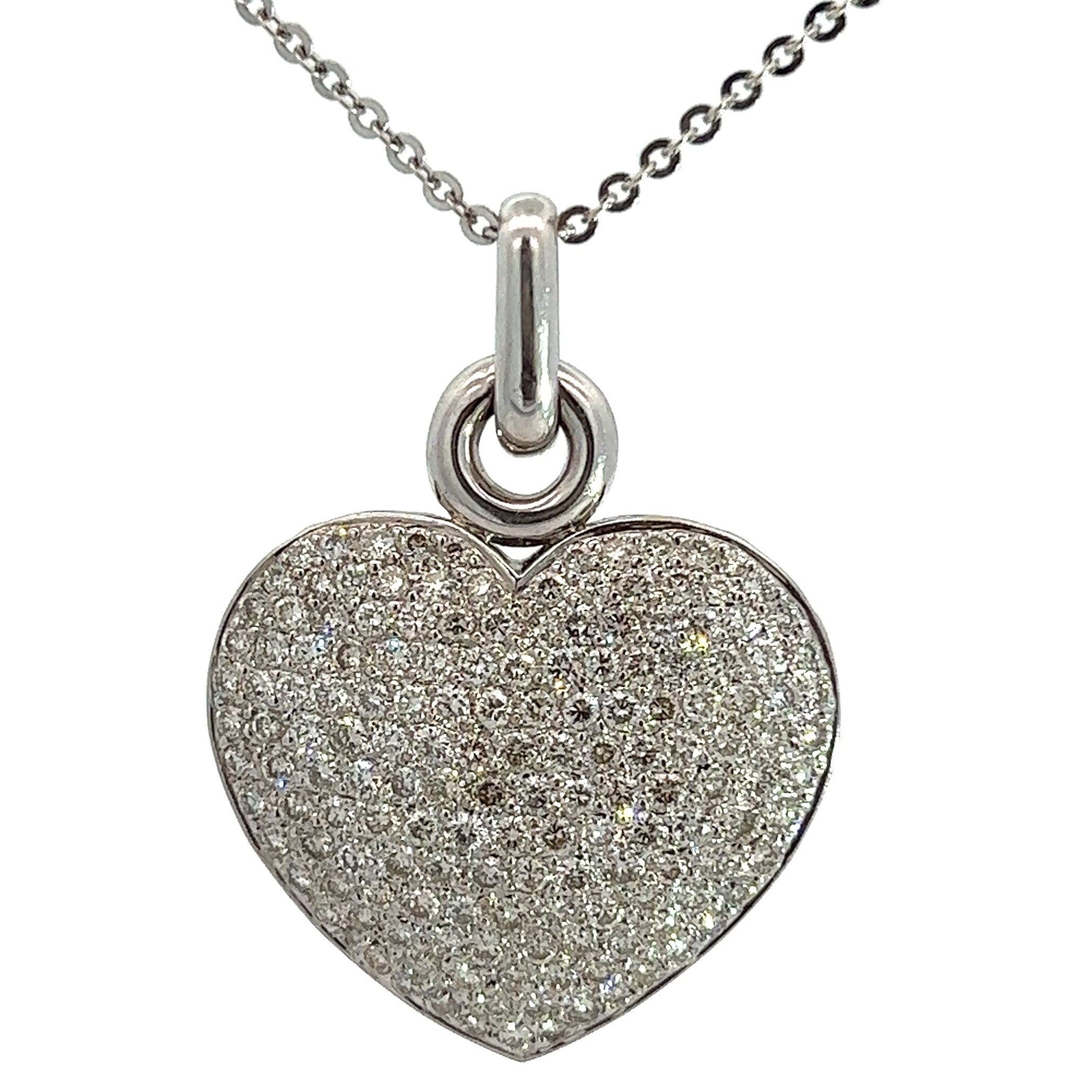 The Modern 14kt White Gold 5.00cttw Round Brilliant Cut Diamond Heart Pendant showcases a sparkling, heart-shaped design encrusted with small, shimmering diamonds. The 14kt white gold pendant is attached to a delicate silver chain with small, round links. The plain white background accentuates the elegance of the jewelry.